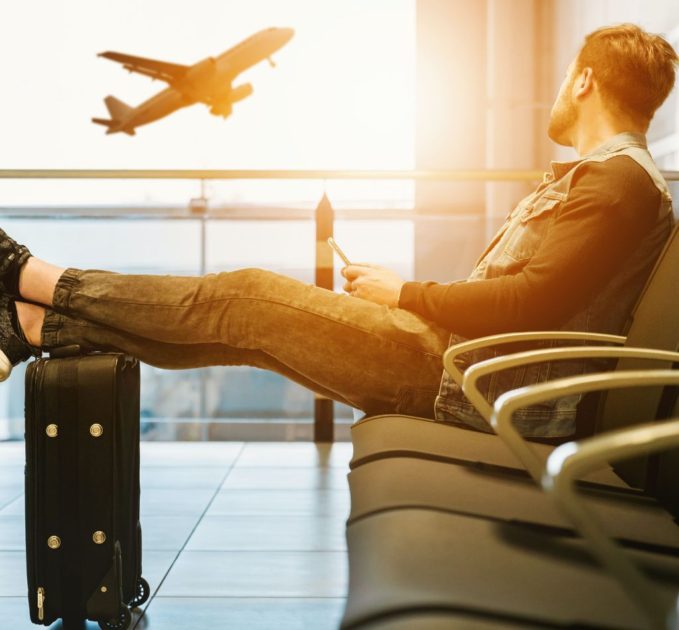 Man sitting at airport during sunset