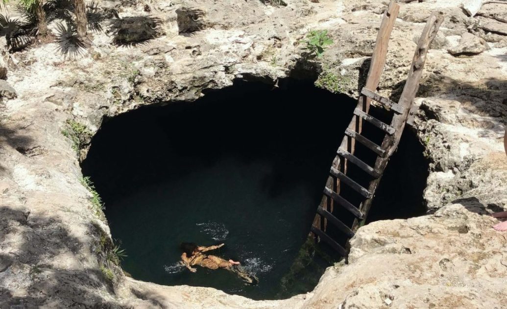 Hole of water with a wooden ladder