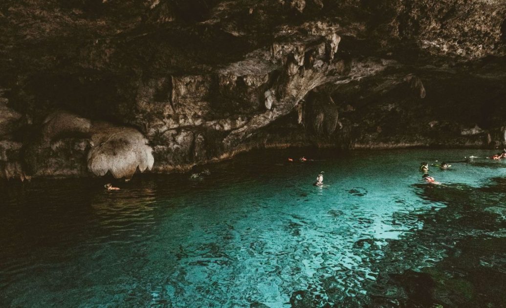 People swimming in cenote