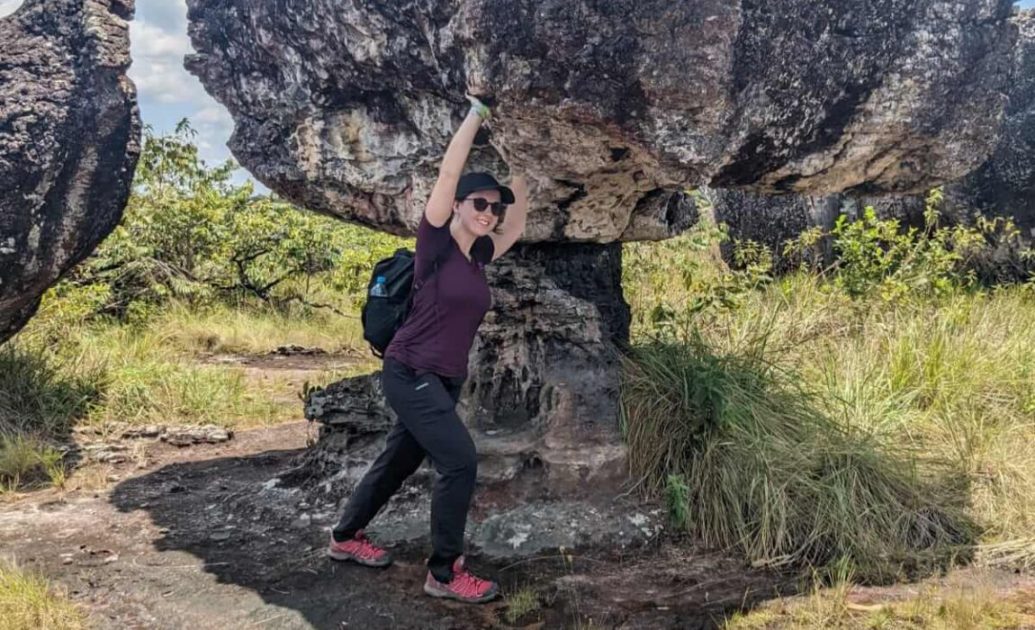 Woman in front of stone formation